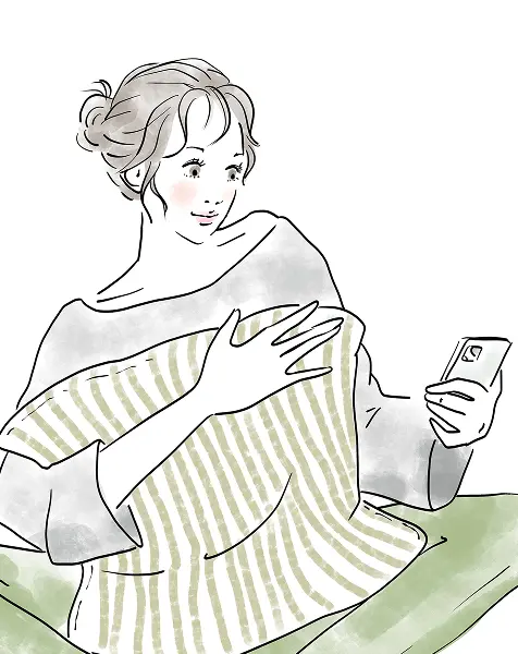 スマートフォンでレッスン予約をしているさま